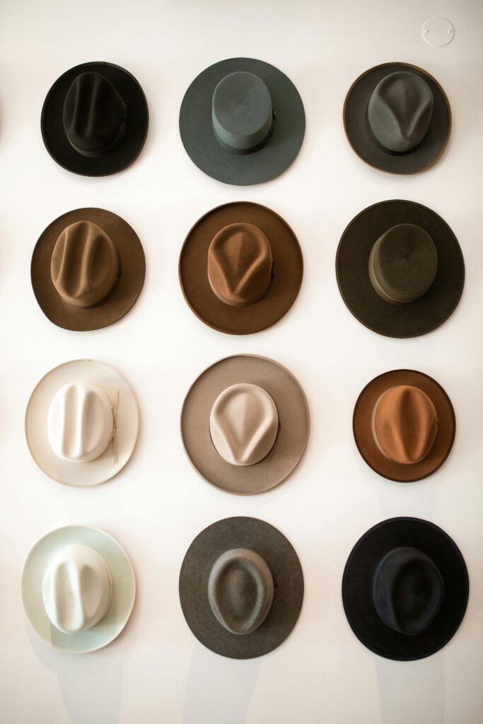pexels-photo-5698909-5698909 A stylish collection of fedora hats arranged on a white wall, offering a glimpse into classic fashion.